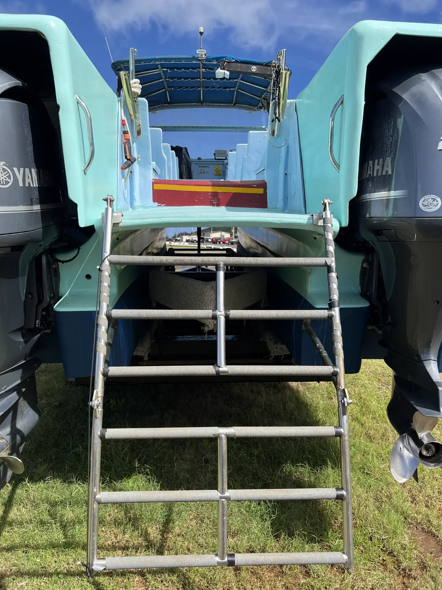 Stern of the Ikaika with twin outboard engines and boarding ladder