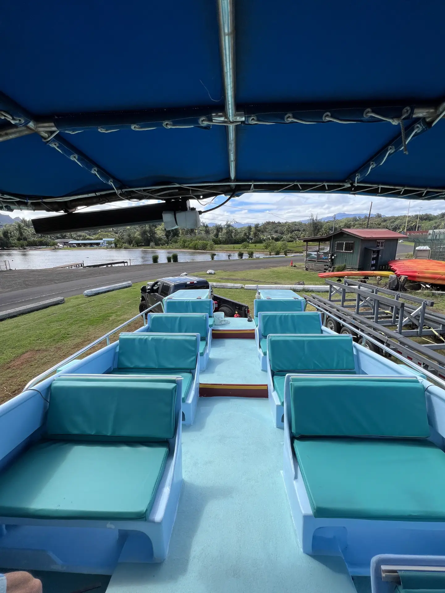 Open-air cushioned seating under the shade canopy aboard the Ikaika