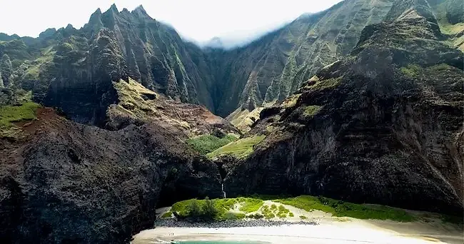 Nā Pali Coast cliffs, waterfall, and secluded beach